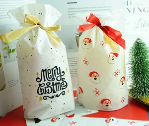 Detail view of Christmas candy gift bags with Santa Claus and Merry Christmas print patterns.
