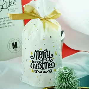 Christmas plastic gift bags with gold ribbon drawstrings, festive candy packaging pouches.