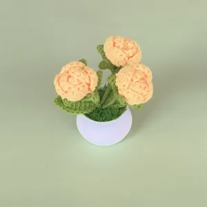 Handcrafted crochet rose potted plant detail view, showing delicate wool texture and neat stitches.