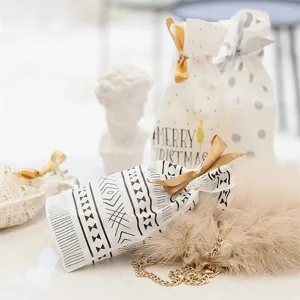 Drawstring gift bags with ribbons for holiday candy, apple and party favor packaging.