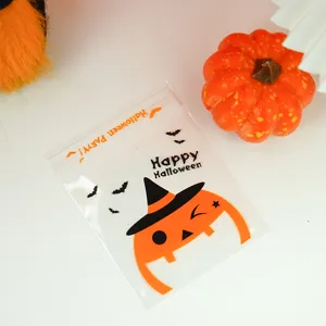Close-up detail view of transparent plastic Halloween candy packaging bag with pumpkin print.