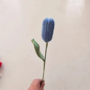 Handcrafted blue crochet tulip flower detail, single stem knit floral decor for home.
