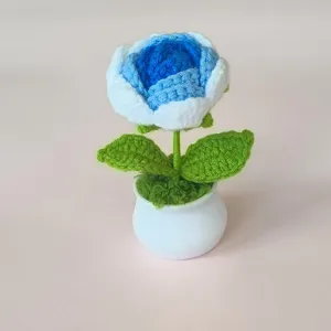 Handmade crochet blue rose potted plant, cute knitted artificial flower desktop variant.