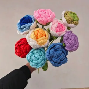 Close-up detail of hand-knitted crochet rose bouquet with vibrant multi-color wool flowers.