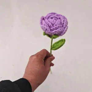 Handmade crochet purple rose flower with green leaves, perfect gift for Valentine's Day.