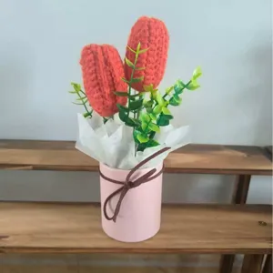 Handmade crochet red flower bouquet potted in pink pot with green leaves for home decor gift.