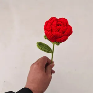 Handmade crochet red rose flower close up detail shot romantic gift handmade decor.