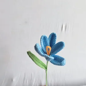 Handcrafted crochet blue flower with green leaf, beautiful knitted floral gift for friends.