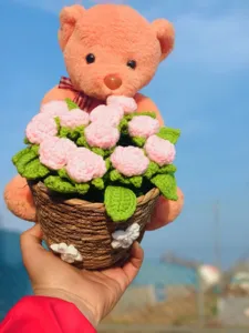 Handmade crochet yarn bear flower bouquet detail, cute knitted gift ornament for birthday.