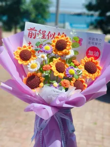 Handmade crochet sunflower bouquet detail view with purple wrapping paper and gift card.