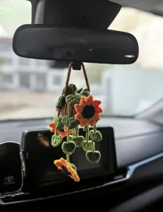 Detailed shot of crochet sunflower car hanging ornament, cute rearview mirror decor basket.