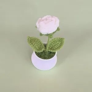 Handmade crochet white rose potted plant detail showing delicate wool yarn texture and finish.