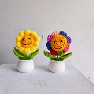 Close-up view of handmade crochet smiley sunflower potted plants for cute home decor.
