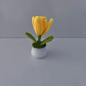 Handmade crochet yellow tulip potted plant detail, showcasing cute knitted floral home decor.