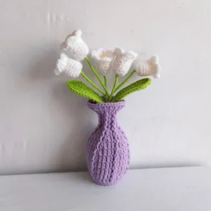 Handmade crochet lily of the valley flowers in purple vase close-up product detail view