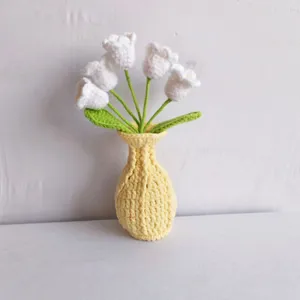 Handmade crochet flower pot detail, cute knitted yarn tulip bouquet home decor ornament.