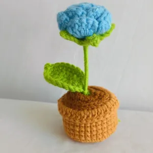 Handmade crochet potted flower detail view, beautiful blue yarn plant for home office decor.