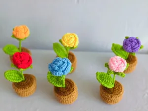 Handmade crochet rose potted plant, colorful knitted flower decor for home, office or car interior.