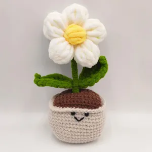 Close-up detail of the handmade crochet puff flower potted plant with cute smiley pot.