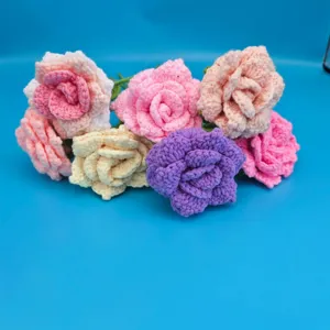 Detailed close-up of handmade crochet wool rose flowers bouquet, colorful yarn flower decor.