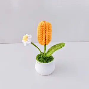 Handmade crochet tulip potted plant detail, cute wool knitted flower home decor ornament.