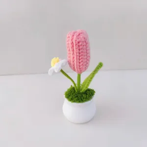 Handmade crochet tulip potted plant detail shot, cute knitted flower decor for home.