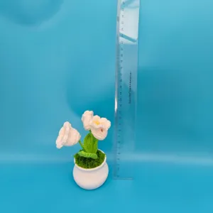 Handmade crochet potted flower detail view, cute knitted floral decor for home desktop.
