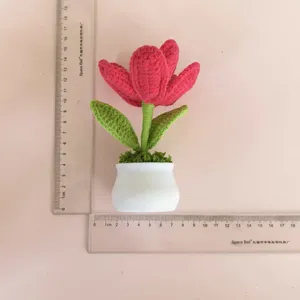 Detailed view of handmade crochet tulip potted plant, cute desk decor item, fine texture.