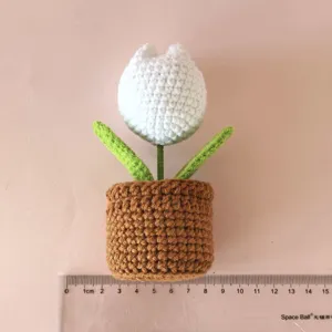 Handmade crochet white tulip potted plant detail view, cute desktop decoration crochet flower.