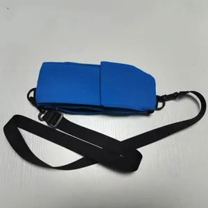 Close-up detail of blue multi-functional travel pouch and black strap for outdoor storage.