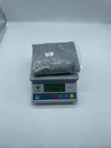 Detail shot of grey travel U-shaped pillow in packaging, weighing 152.3g on scale.
