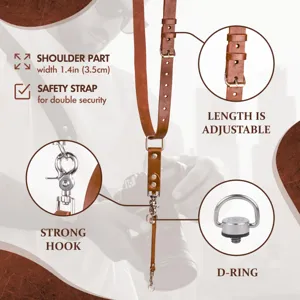 Detailed view of the brown leather camera strap highlighting adjustable length and strong hooks.