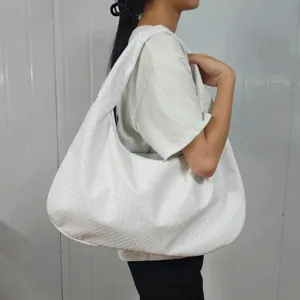 Handmade woven white hobo shoulder bag for women, stylish underarm crescent handbag.