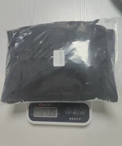 Garden tool waist bag packaging detail showing weight measurement on digital scale.