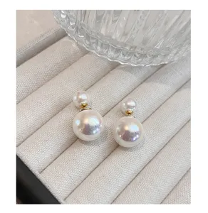Exquisite double pearl earrings featuring front and back shell pearls with elegant gold tone.