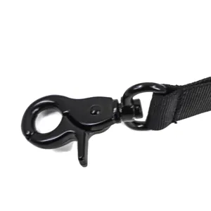 Close up of black metal snap hook and durable nylon strap for pet dog leash and tactical harness.
