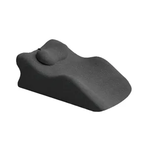 Detail view of the ergonomic grey positioning pillow, showing the soft curved contour and shape.