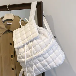 White quilted down backpack detail shot, stylish puffy design for casual daily use.