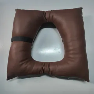 Anti-bedsore cushion for bedridden patients, breathable hollow nursing pillow in brown leather.