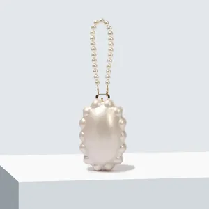 Exquisite pearl evening bag with beaded handle, elegant acrylic shell clutch for women.