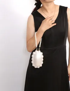 Elegant pearl handle evening handbag for women, chic shell design clutch for parties.