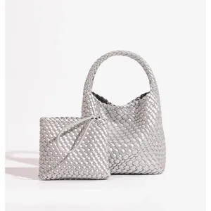 Close-up details of the stylish silver woven leather handbag and matching pouch set.