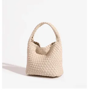 Detailed view of the beige woven leather handbag, premium intrecciato texture, elegant daily carry.