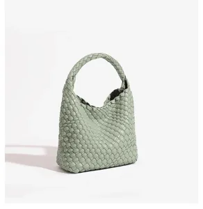 Close-up detail of light green woven leather handbag, showcasing the exquisite intreccio design.