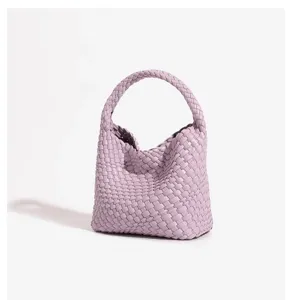 Exquisite woven leather handbag detailed view, showcasing the fine craftsmanship and texture.