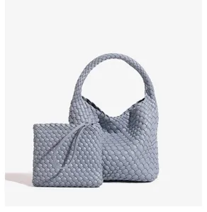 Detailed close-up view of light blue woven leather hobo handbag and matching pouch.