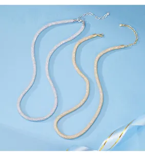 Close-up detail view of elegant double-color rhinestone tube choker necklaces in silver and gold.