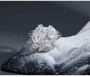 Close-up detail of baroque irregular square pearl ring with silver rope and sparkling leaves.
