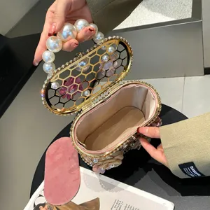 Borsa pochette da sera in metallo con strass e perle, design a nido d'ape elegante.