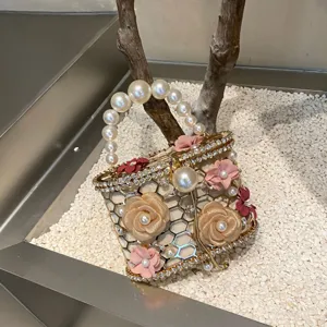 Dettaglio della borsa di perle scintillanti con strass brillanti e decori floreali.